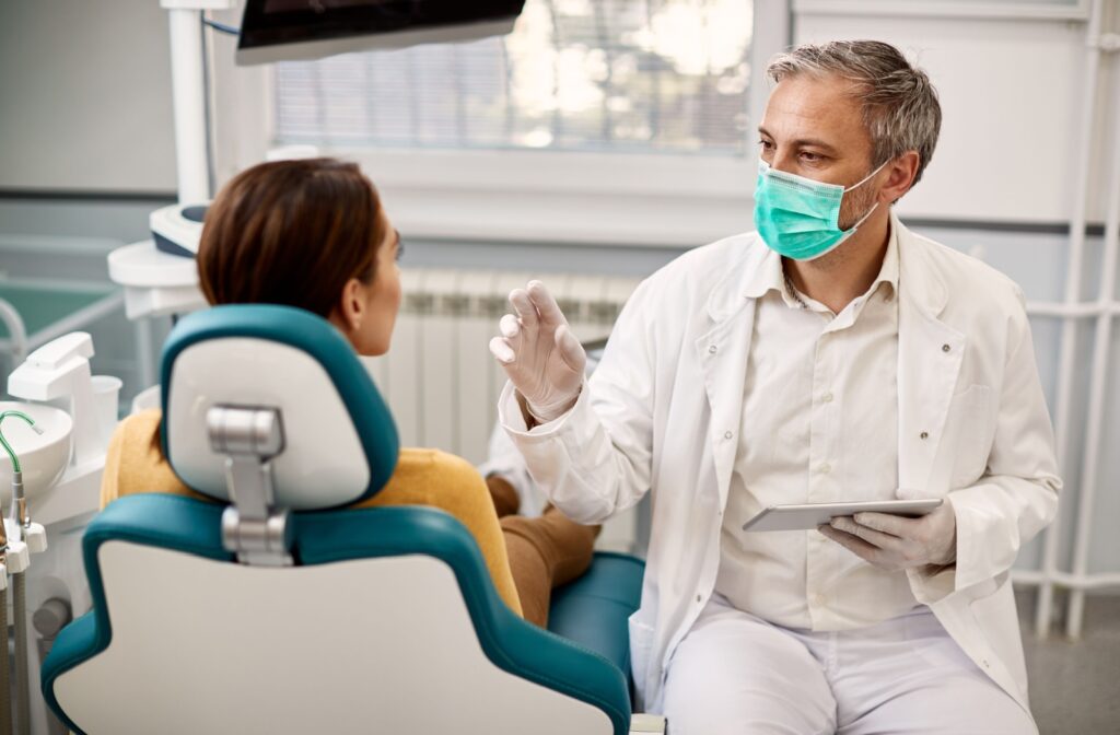 A dentist explains aftercare instructions following a patient's tooth extraction.